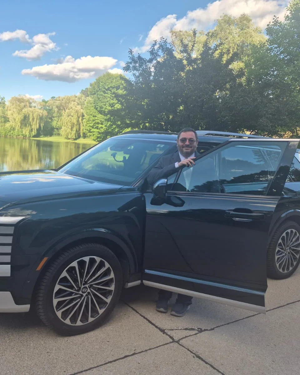 Mark beside his SUV at a lakeside pickup, ready for a Detroit Metro (DTW) airport ride